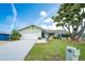 Charming single-story home with a well-maintained lawn, mature shade tree, and an attached two-car garage at 909 Silver Palm Way, Apollo Beach, FL 33572