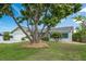Beautifully landscaped front yard with mature trees and a well-maintained lawn, adding curb appeal at 909 Silver Palm Way, Apollo Beach, FL 33572