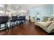 Bright open-concept living space with wood floors, bar seating, and plenty of natural light at 909 Silver Palm Way, Apollo Beach, FL 33572