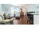 Well-lit living area with stylish furnishings, wood flooring, and an open view to the front entrance at 909 Silver Palm Way, Apollo Beach, FL 33572