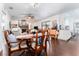 Open living room with a dining table and access to the kitchen, along with a stone fireplace at 909 Silver Palm Way, Apollo Beach, FL 33572
