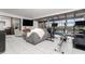 Spacious living room area featuring tile floors, comfortable seating, and workout equipment with beautiful outdoor views at 909 Silver Palm Way, Apollo Beach, FL 33572