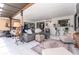 Cozy living room with tile flooring, comfortable seating, a bar area, and a workout space for relaxation and entertainment at 909 Silver Palm Way, Apollo Beach, FL 33572