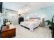 Serene main bedroom with soft blue walls, ceiling fan, and neutral decor creating a relaxing retreat at 909 Silver Palm Way, Apollo Beach, FL 33572