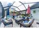 Inviting screened patio with a pool, stylish furniture, and outdoor seating at 909 Silver Palm Way, Apollo Beach, FL 33572