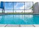 Close-up of sparkling blue pool water with scenic views and a screen enclosure at 909 Silver Palm Way, Apollo Beach, FL 33572