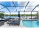 Screened pool with beautiful water views and outdoor kitchen at 909 Silver Palm Way, Apollo Beach, FL 33572
