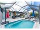 Relaxing screened-in pool area with a covered patio, lounge chairs, and lush greenery at 909 Silver Palm Way, Apollo Beach, FL 33572