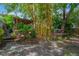 A backyard featuring lush, tropical landscaping, koi pond, outdoor kitchen, and covered patio at 1042 S Sterling Ave, Tampa, FL 33629