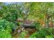 Lush backyard pond with a charming bridge and serene waterfall feature at 1042 S Sterling Ave, Tampa, FL 33629