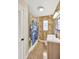 Bathroom featuring a toilet, vanity, wood look wall, and shower-tub combo at 1042 S Sterling Ave, Tampa, FL 33629