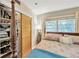 Cozy bedroom featuring a four-poster bed, closet space, and natural light at 1042 S Sterling Ave, Tampa, FL 33629