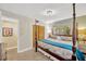 Comfortable bedroom with a four-poster bed, closet, and a light fixture at 1042 S Sterling Ave, Tampa, FL 33629