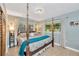 Charming bedroom featuring four-poster bed, multiple windows, and soft color scheme at 1042 S Sterling Ave, Tampa, FL 33629
