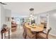 Bright dining room with wicker chairs, terrazzo floors, and unique hanging pendant lights at 1042 S Sterling Ave, Tampa, FL 33629