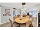 Well-lit dining room with coastal mural, wicker chairs, and pendant lighting at 1042 S Sterling Ave, Tampa, FL 33629