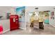 Bright dining room with beach themed wallpaper, wicker furniture, and vintage Coca-Cola machine at 1042 S Sterling Ave, Tampa, FL 33629