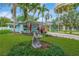 Quaint home featuring a covered carport, manicured lawn, and mature palm trees for a tropical feel at 1042 S Sterling Ave, Tampa, FL 33629