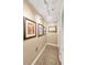 Hallway featuring decorative framed art, speckled flooring, and clean white trim at 1042 S Sterling Ave, Tampa, FL 33629