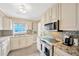 Updated kitchen showcasing stainless steel appliances, granite countertops, and mosaic backsplash at 1042 S Sterling Ave, Tampa, FL 33629