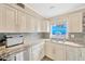 Classic kitchen featuring granite counters, tile backsplash, stainless steel appliances and a window at 1042 S Sterling Ave, Tampa, FL 33629