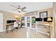 Well-lit home office with ample desk space, French doors to the backyard and ceiling fan at 1042 S Sterling Ave, Tampa, FL 33629