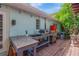 Exterior kitchen featuring granite countertops, a sink, grill, pizza oven, and a mini fridge at 1042 S Sterling Ave, Tampa, FL 33629