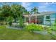 Home exterior with charming garden beds, a covered carport, and lush landscaping for outdoor enjoyment at 1042 S Sterling Ave, Tampa, FL 33629