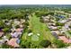 Aerial view of golf course winding through a neighborhood with mature trees and well-manicured lawns at 1358 Forestedge Blvd, Oldsmar, FL 34677