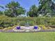 Serene backyard retreat featuring a quaint bench surrounded by lush greenery and manicured landscaping at 1358 Forestedge Blvd, Oldsmar, FL 34677