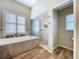 Bright bathroom featuring soaking tub, shower, and tile floor at 1358 Forestedge Blvd, Oldsmar, FL 34677