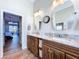 Bathroom featuring a double sink vanity with granite countertop and tile flooring at 1358 Forestedge Blvd, Oldsmar, FL 34677