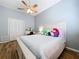 Vaulted ceiling bedroom with a ceiling fan, a writing desk, a closet with bi-fold doors, and wood-look tile flooring at 1358 Forestedge Blvd, Oldsmar, FL 34677