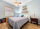 Bedroom featuring wood floors, fan, and side tables at 1358 Forestedge Blvd, Oldsmar, FL 34677