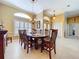 Elegant dining room with stylish furnishings, tile flooring, and a decorative chandelier at 1358 Forestedge Blvd, Oldsmar, FL 34677