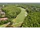 Scenic aerial view of a golf course with lush green fairways surrounded by mature trees at 1358 Forestedge Blvd, Oldsmar, FL 34677