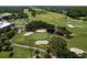 Aerial view of green on a golf course featuring sand traps and a scenic pond at 1358 Forestedge Blvd, Oldsmar, FL 34677
