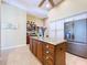 Kitchen island with granite countertops, stainless steel refrigerator, and custom cabinets with ample storage space at 1358 Forestedge Blvd, Oldsmar, FL 34677