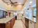 Spacious kitchen with a center island, granite countertops, stainless steel appliances, and tile flooring at 1358 Forestedge Blvd, Oldsmar, FL 34677