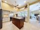 Bright kitchen with stainless steel appliances, granite countertops, and a large center island at 1358 Forestedge Blvd, Oldsmar, FL 34677