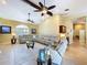 Open concept living room with vaulted ceiling, ceiling fans, and comfortable seating at 1358 Forestedge Blvd, Oldsmar, FL 34677