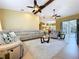 Spacious open concept living room with vaulted ceiling, comfortable seating, and views to pool at 1358 Forestedge Blvd, Oldsmar, FL 34677