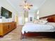Beautiful main bedroom showcasing wood floors, ceiling fan, and ample space at 1358 Forestedge Blvd, Oldsmar, FL 34677