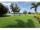 Expansive backyard featuring lush green grass and a serene lake view at 16413 Rivers Reach Blvd, Parrish, FL 34219