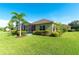 Green backyard featuring a screened-in lanai and mature trees at 16413 Rivers Reach Blvd, Parrish, FL 34219