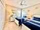 Bright bedroom featuring two twin beds, light wood floors, and a dresser at 16413 Rivers Reach Blvd, Parrish, FL 34219