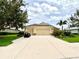 Spacious home with three-car garage, lush lawn, and mature landscaping at 16413 Rivers Reach Blvd, Parrish, FL 34219