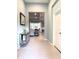 Welcoming foyer with stylish mirror cabinet, leading to the living and dining areas at 16413 Rivers Reach Blvd, Parrish, FL 34219