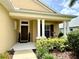 Charming front porch with white columns and manicured landscaping at 16413 Rivers Reach Blvd, Parrish, FL 34219