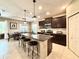 Modern kitchen featuring dark wood cabinets, granite countertops, and stainless steel appliances at 16413 Rivers Reach Blvd, Parrish, FL 34219